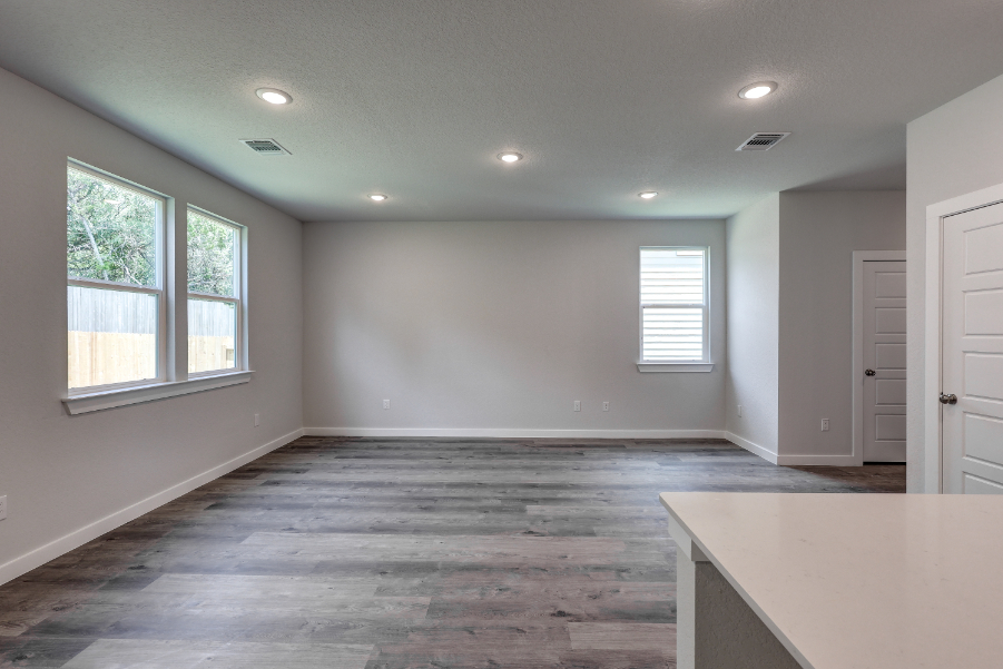 A room with a wood floor and white walls.
