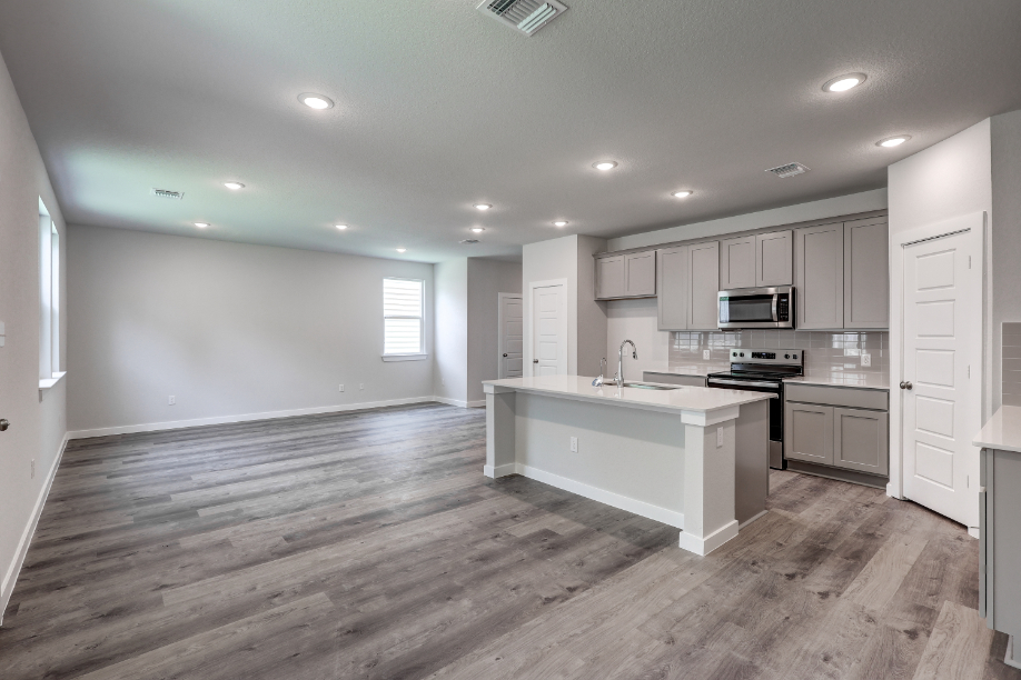 A kitchen with white cabinets.