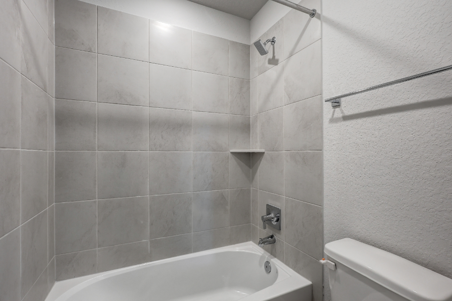 A bathroom with a bathtub and toilet.