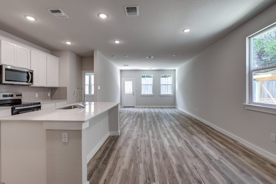 A kitchen with white cabinets.