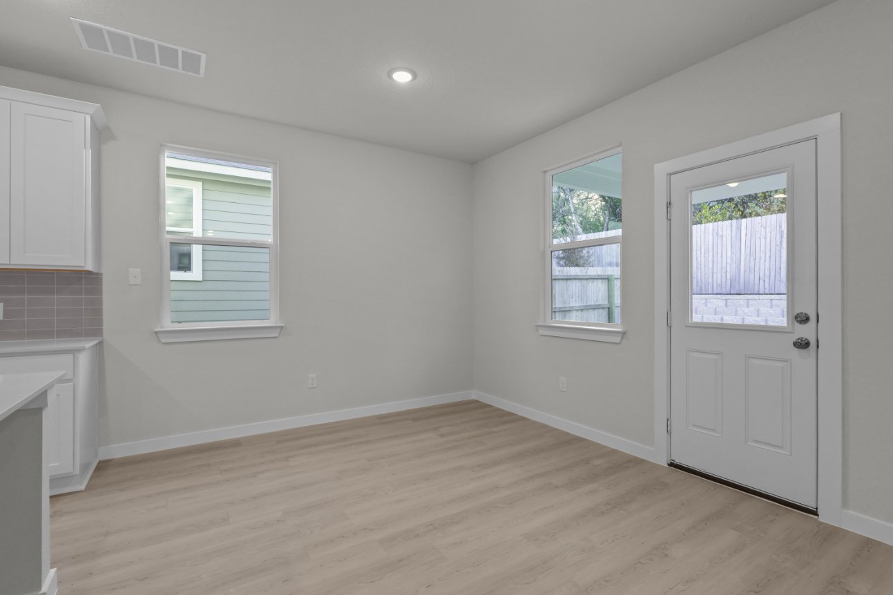 A room with a wood floor and white walls.