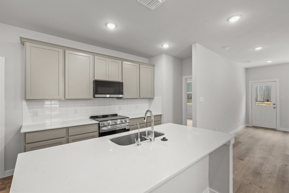 A kitchen with white cabinets.