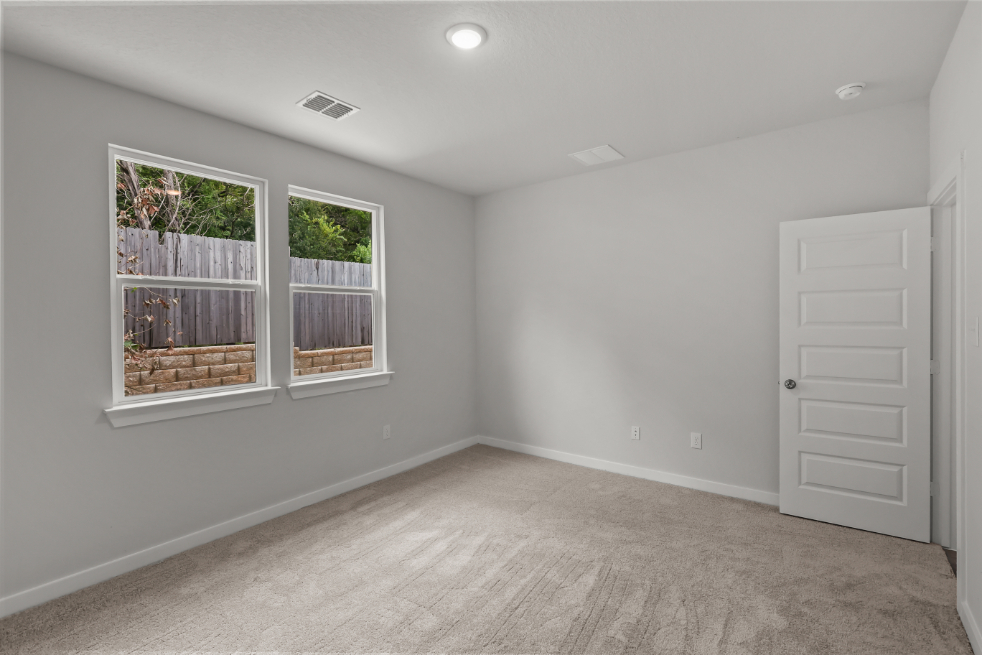 A room with a white door and windows.