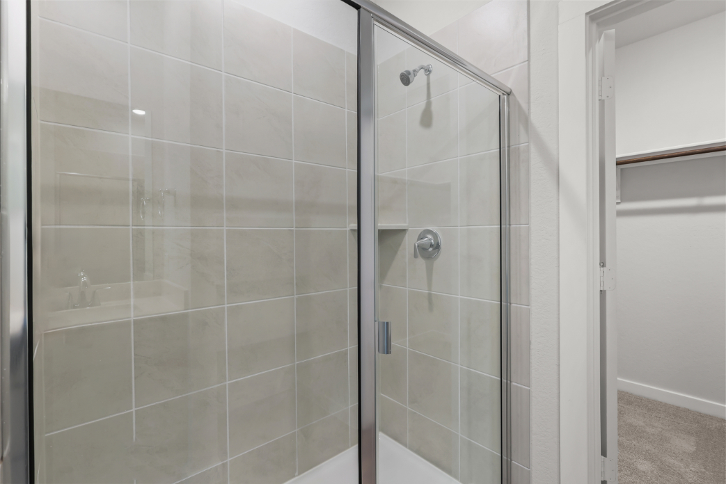 A shower with a glass door.
