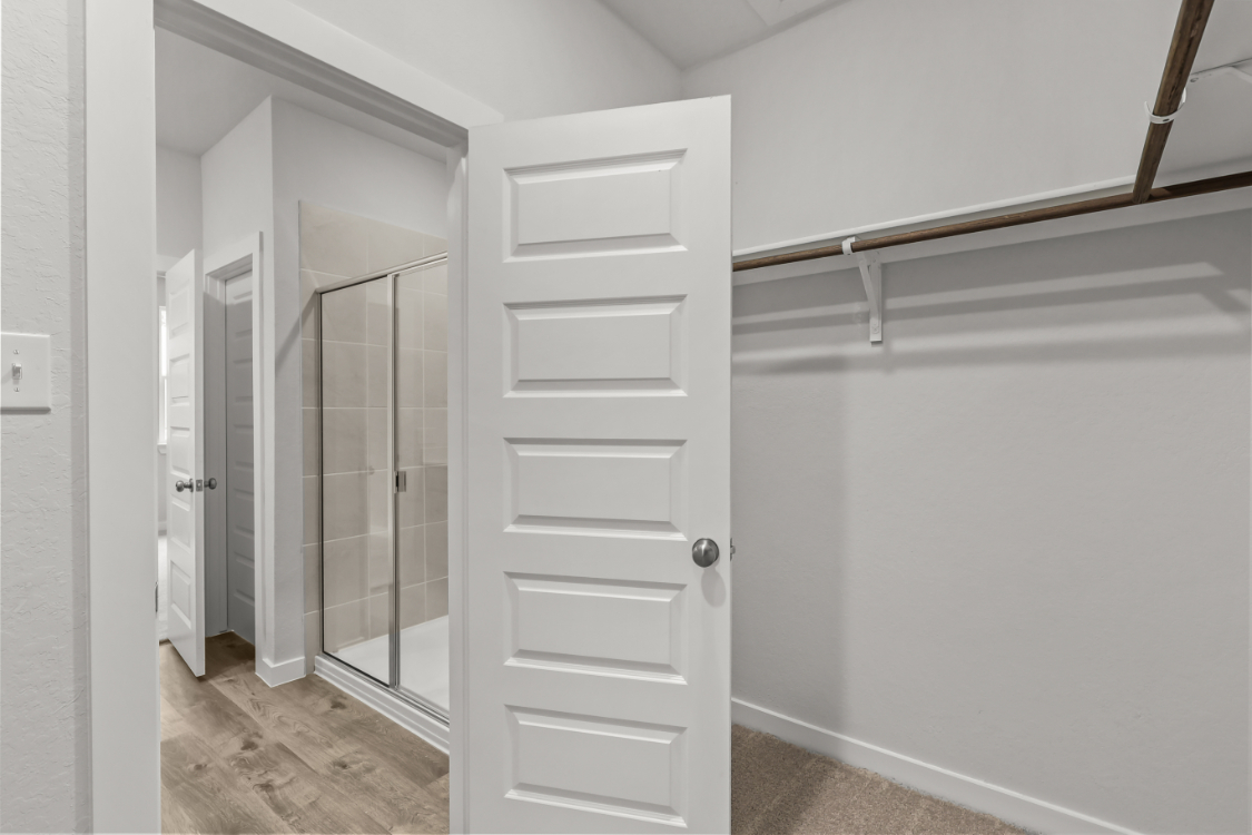 A white closet with a glass door.