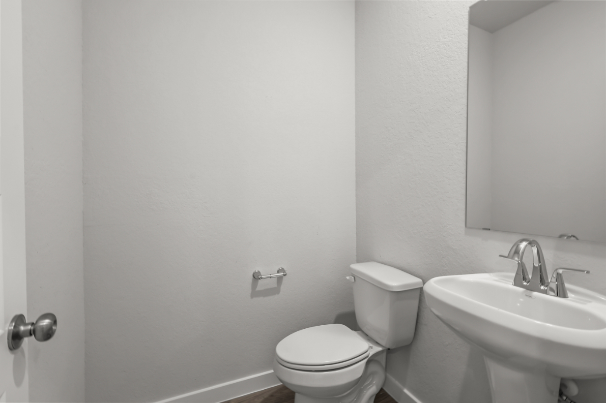 A bathroom with a toilet and sink.