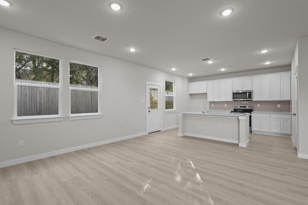 A kitchen with white cabinets.