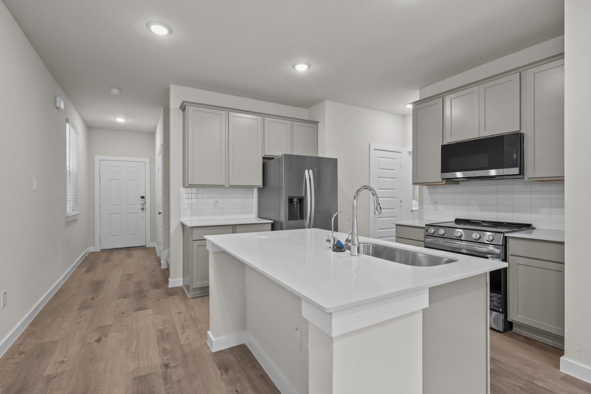 A kitchen with white cabinets.