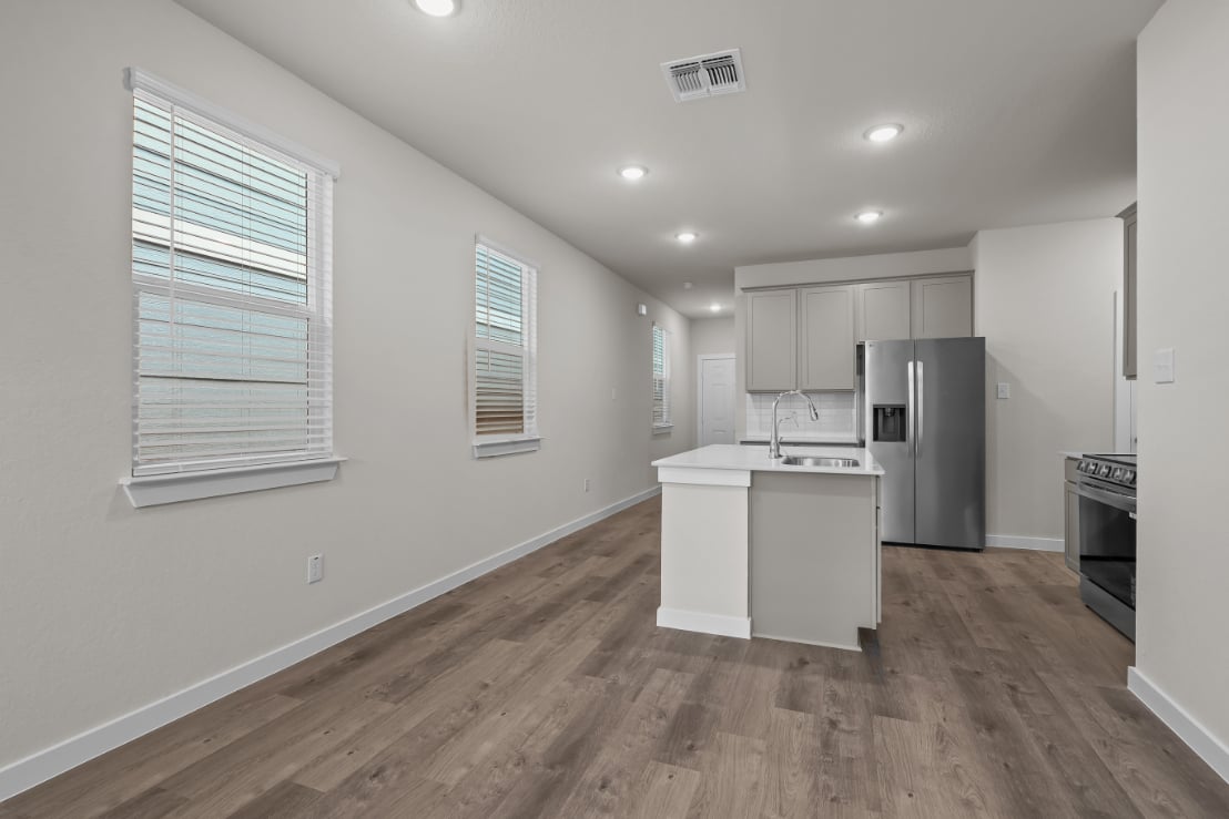 A kitchen with white cabinets.