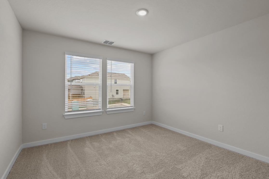 A room with a window and a carpet.