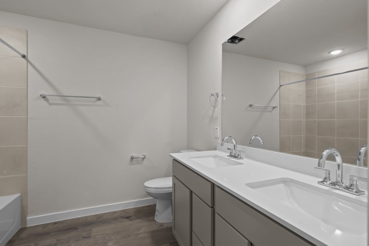 A bathroom with a large mirror.