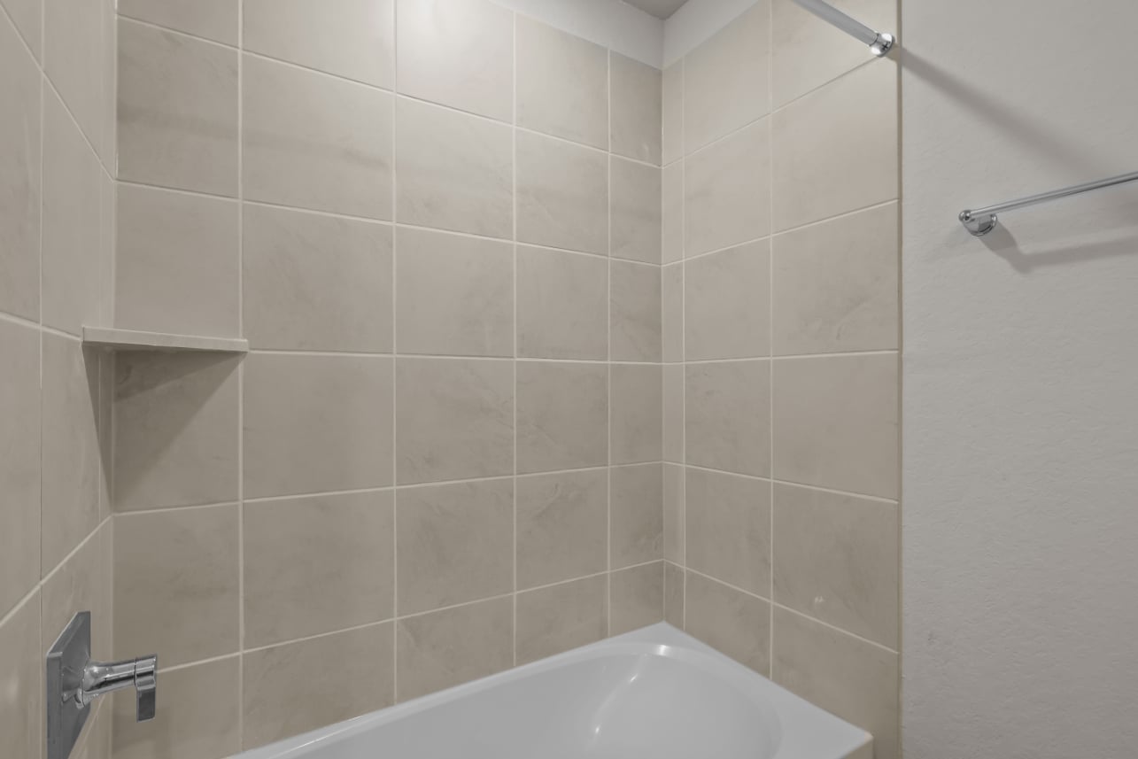 A bathtub in a bathroom.