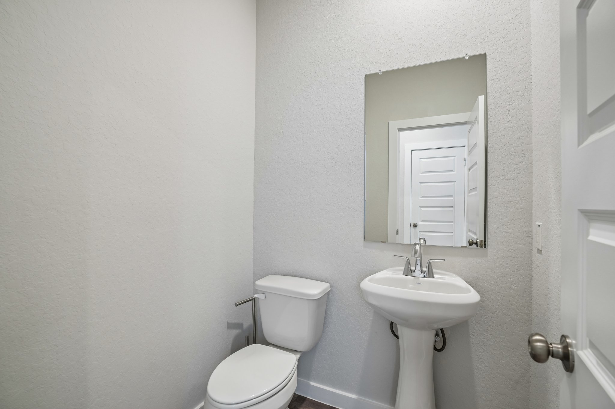 A bathroom with a toilet and sink.