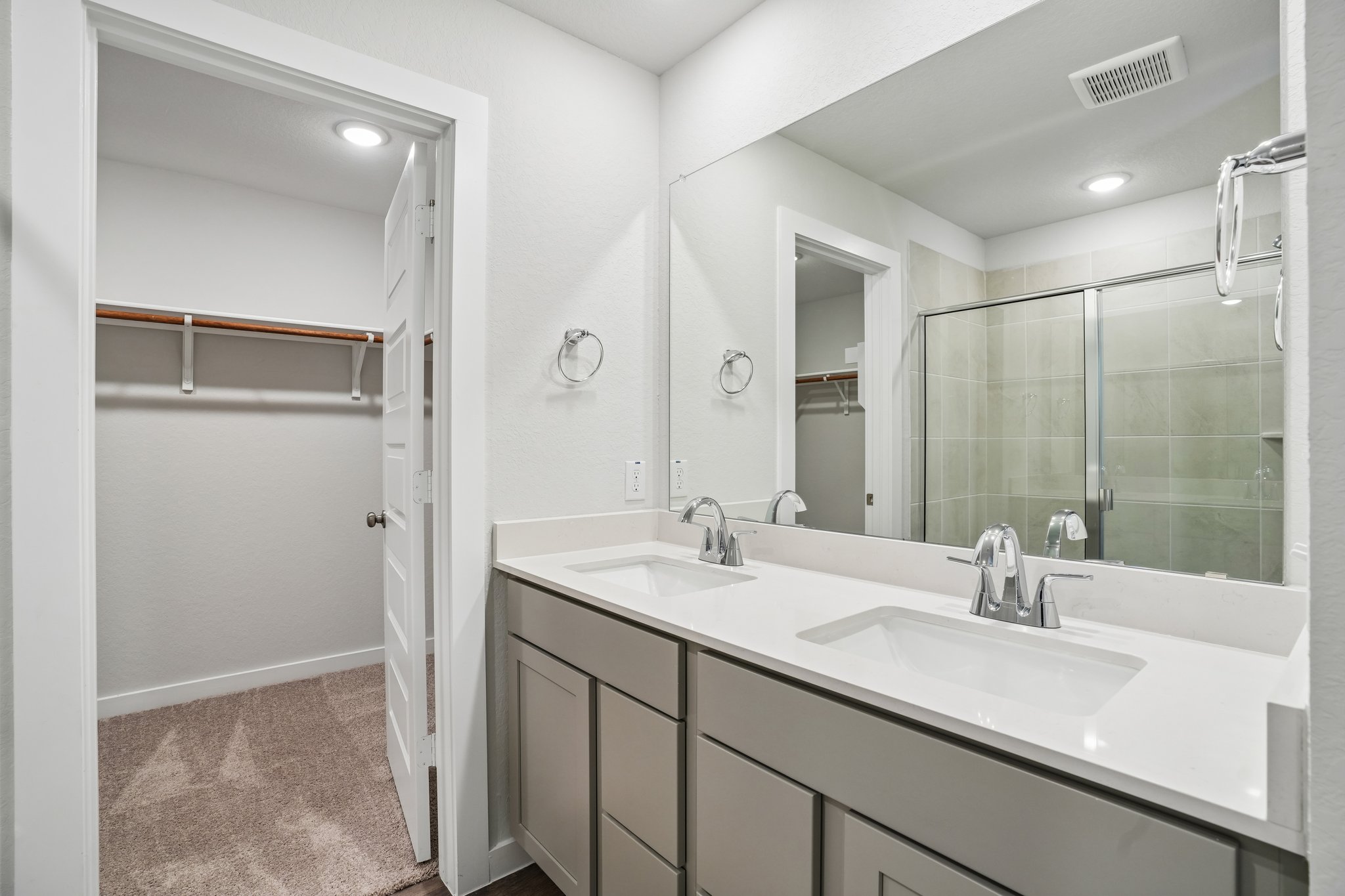 A bathroom with a large mirror.