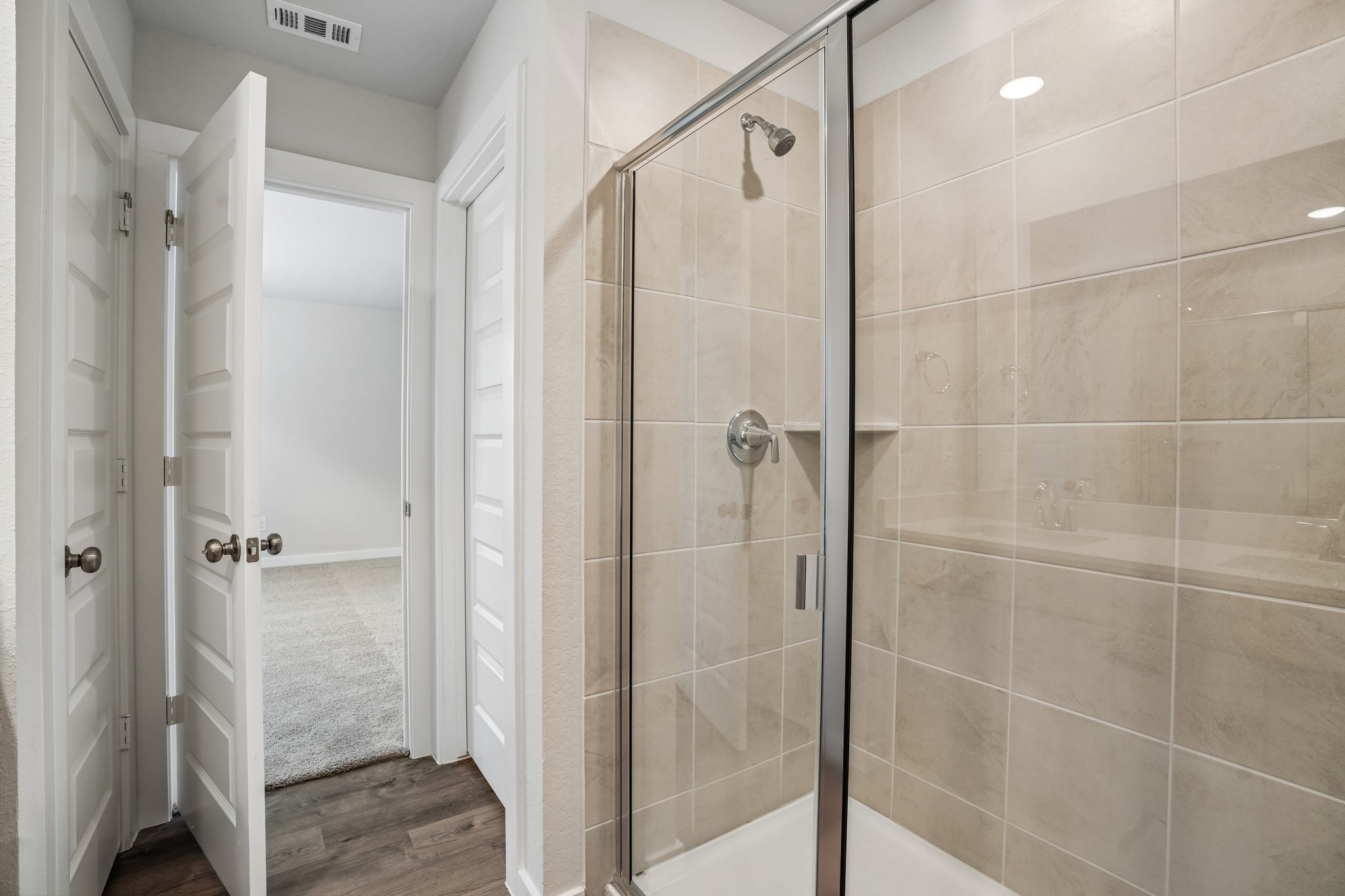 A shower with a glass door.