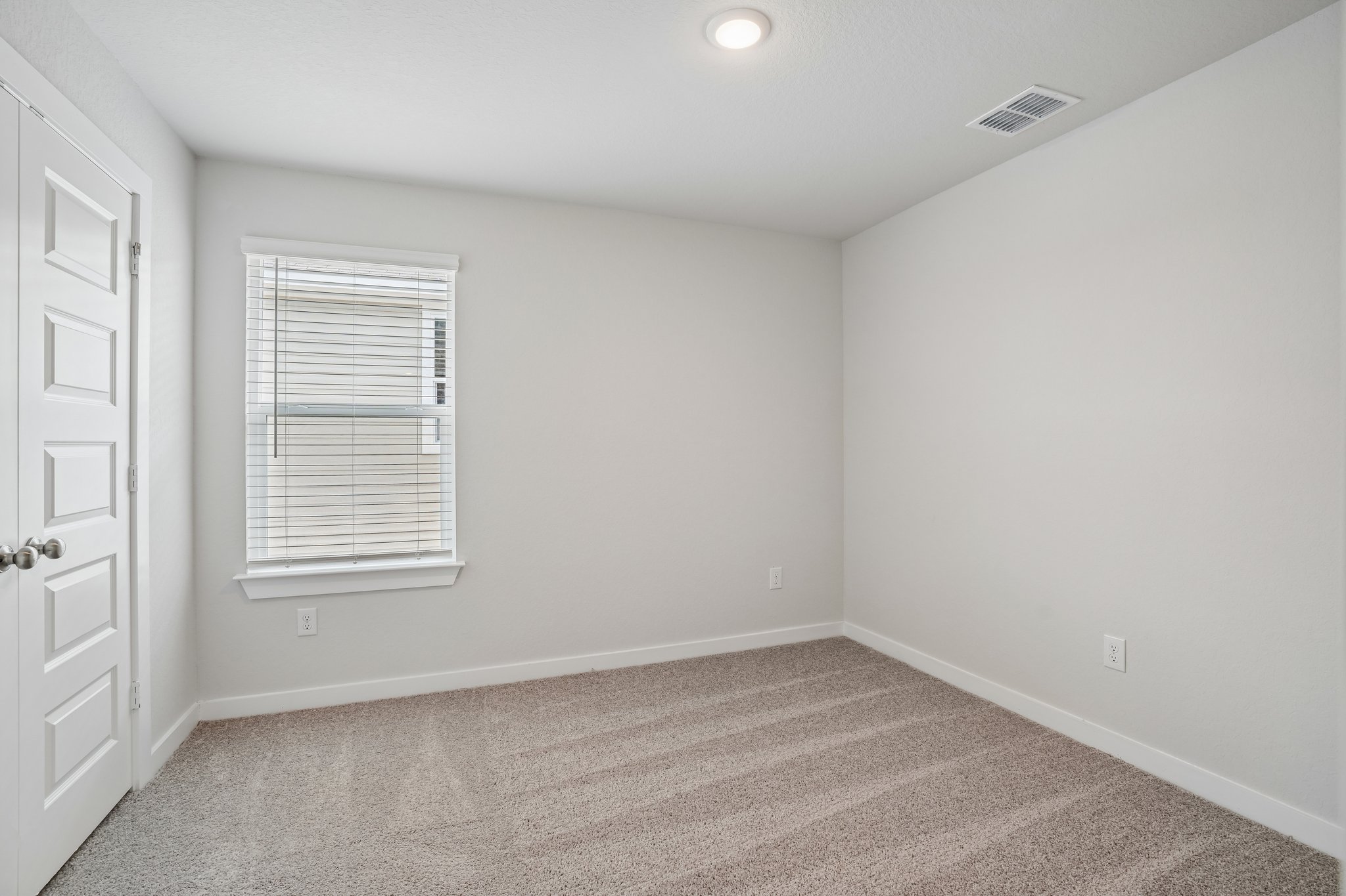A room with a door and a window.