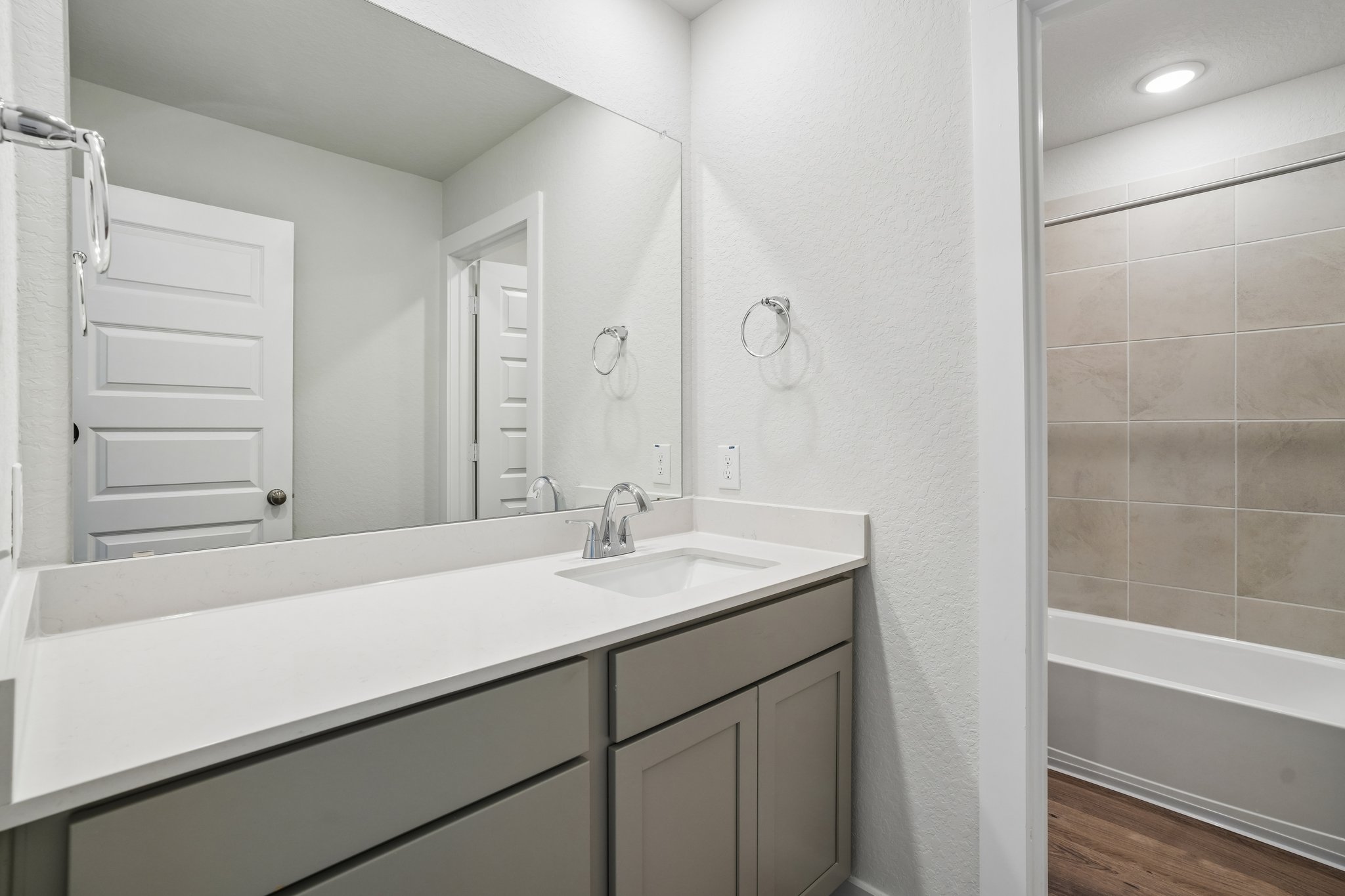 A bathroom with a sink and a bathtub.