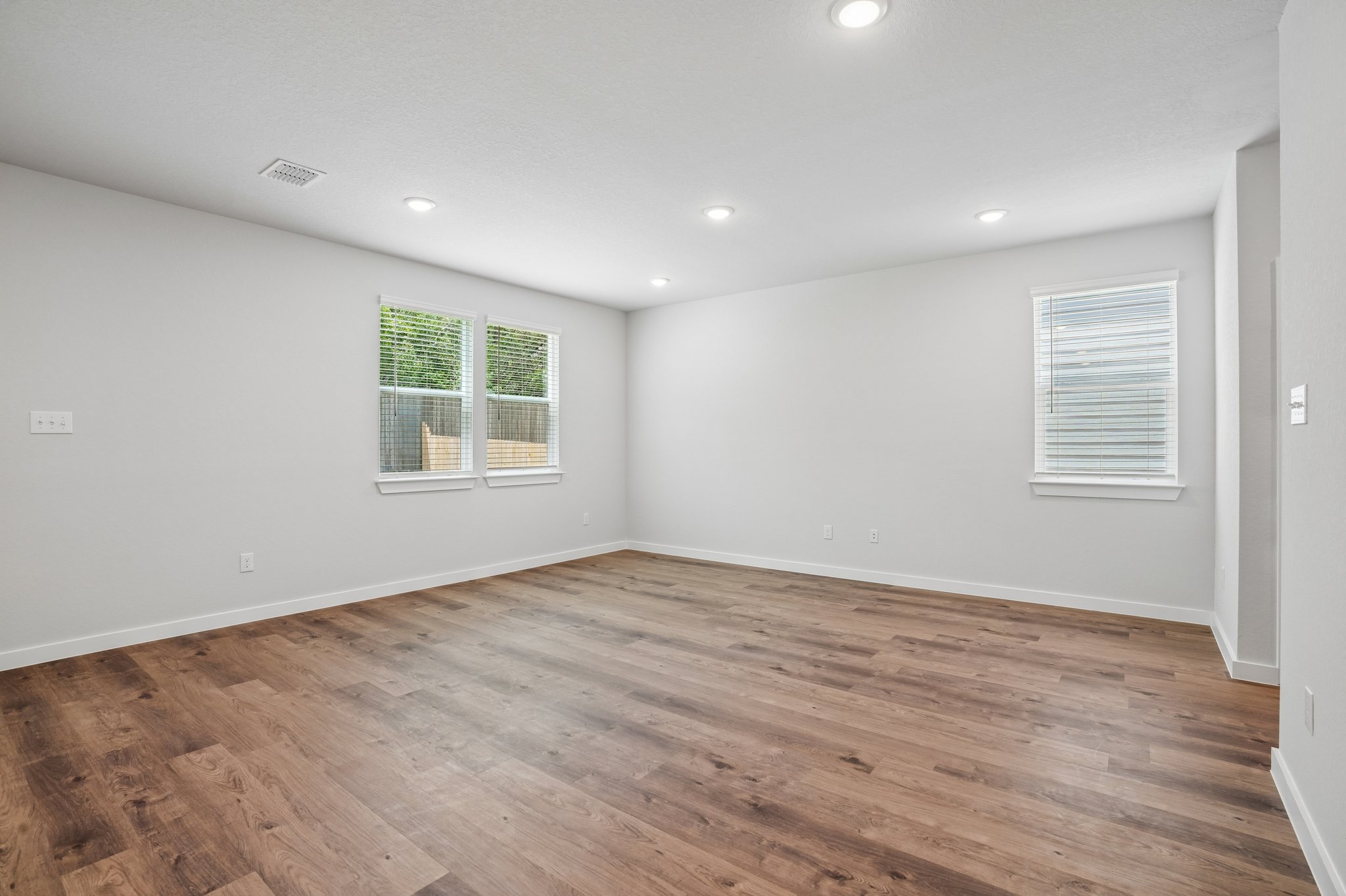 A room with a wood floor and a wood floor.
