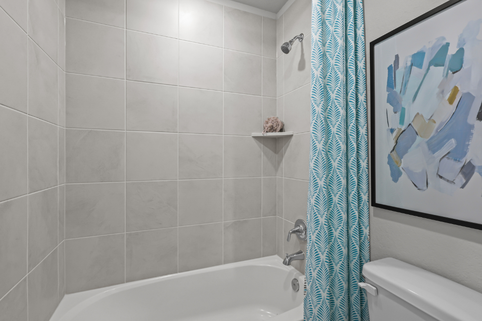 A bathroom with a bathtub and toilet.