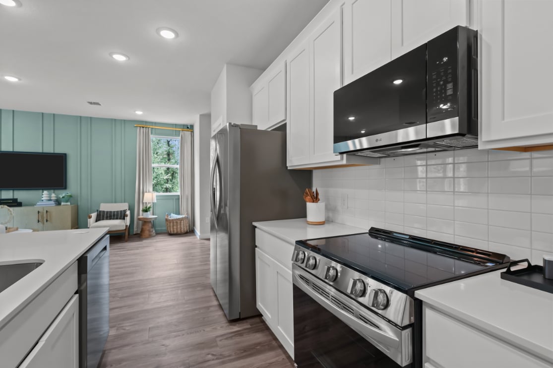 A kitchen with white cabinets.