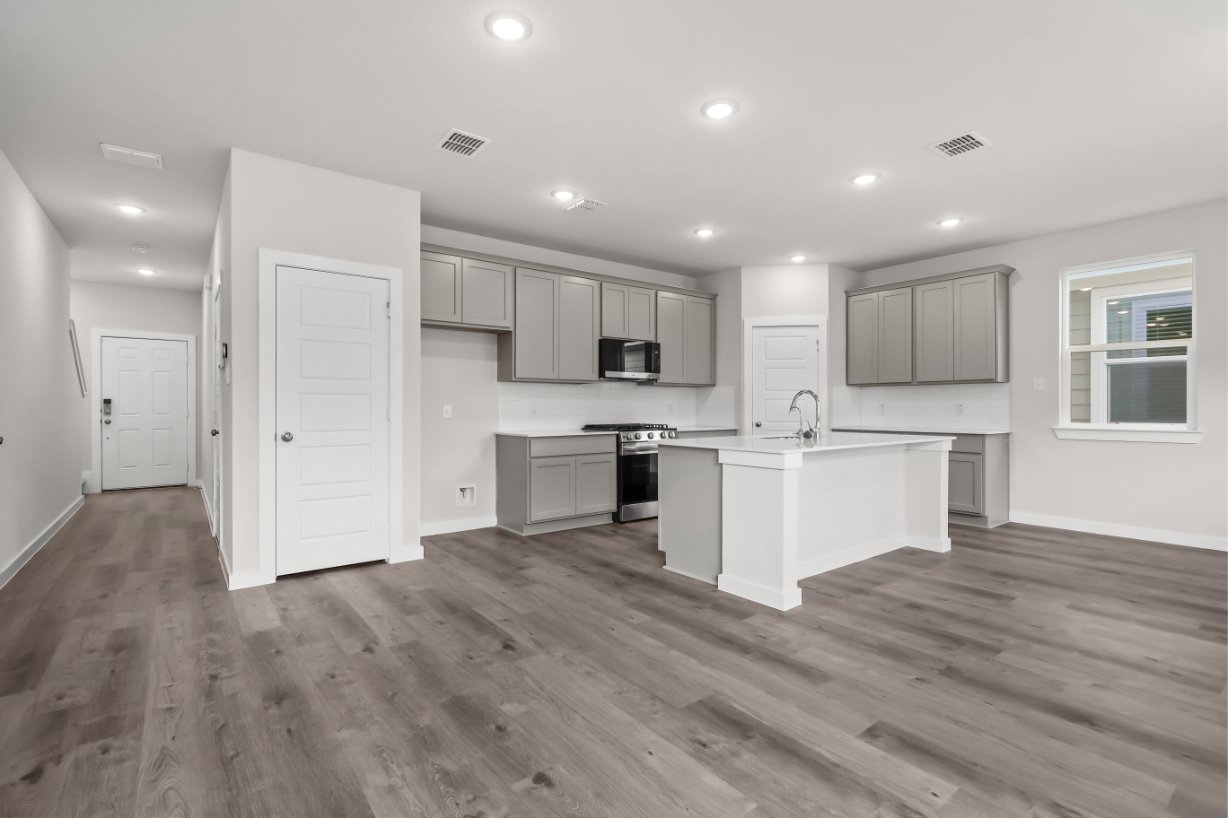 A kitchen with white cabinets.
