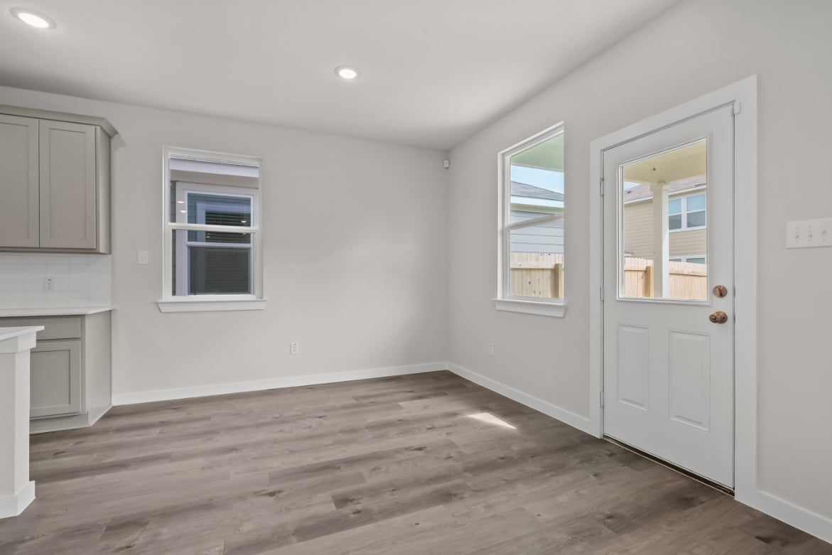 A room with white walls and a wood floor.