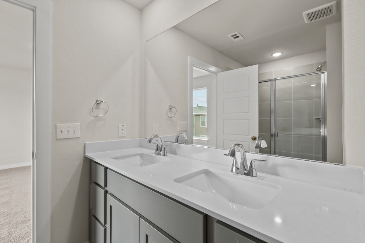 A bathroom with a large mirror.