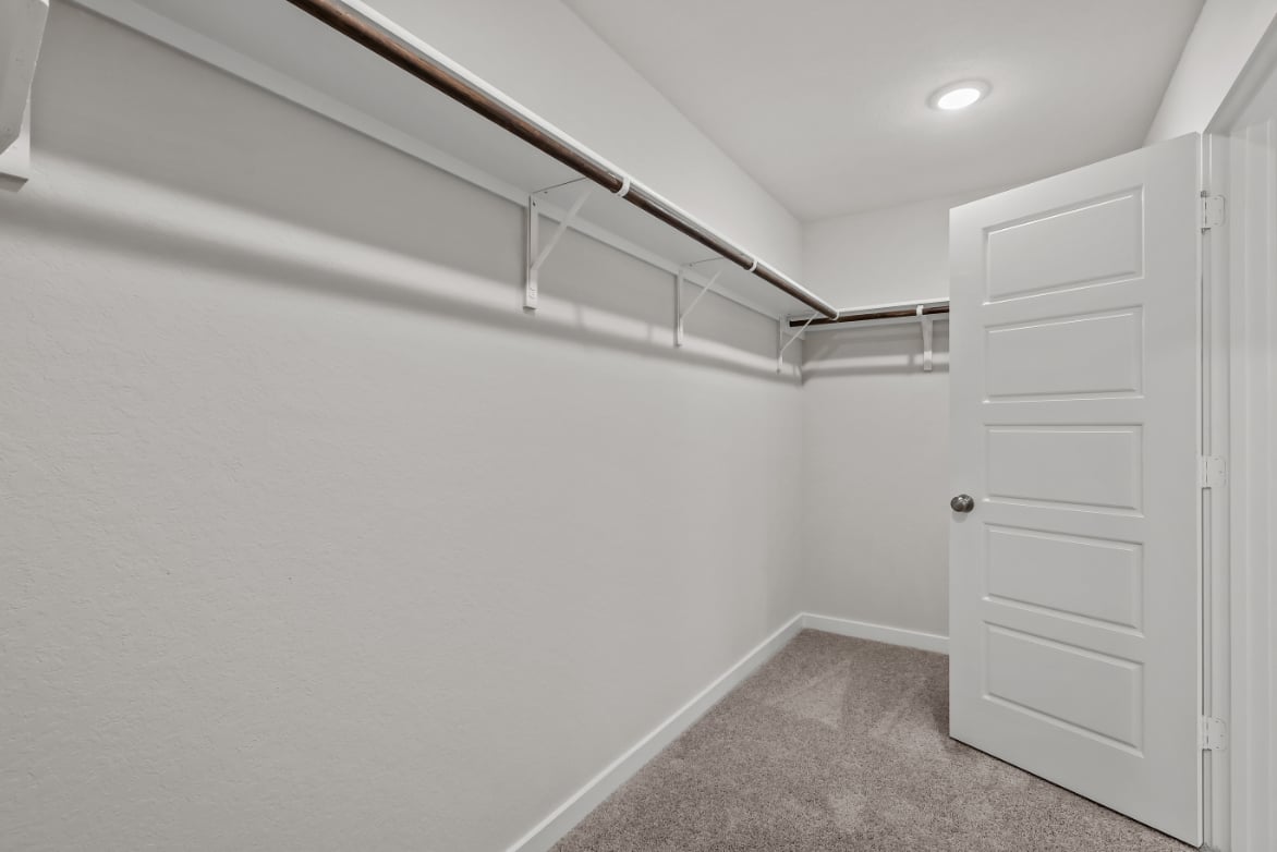 A white room with a white door and a white wall.