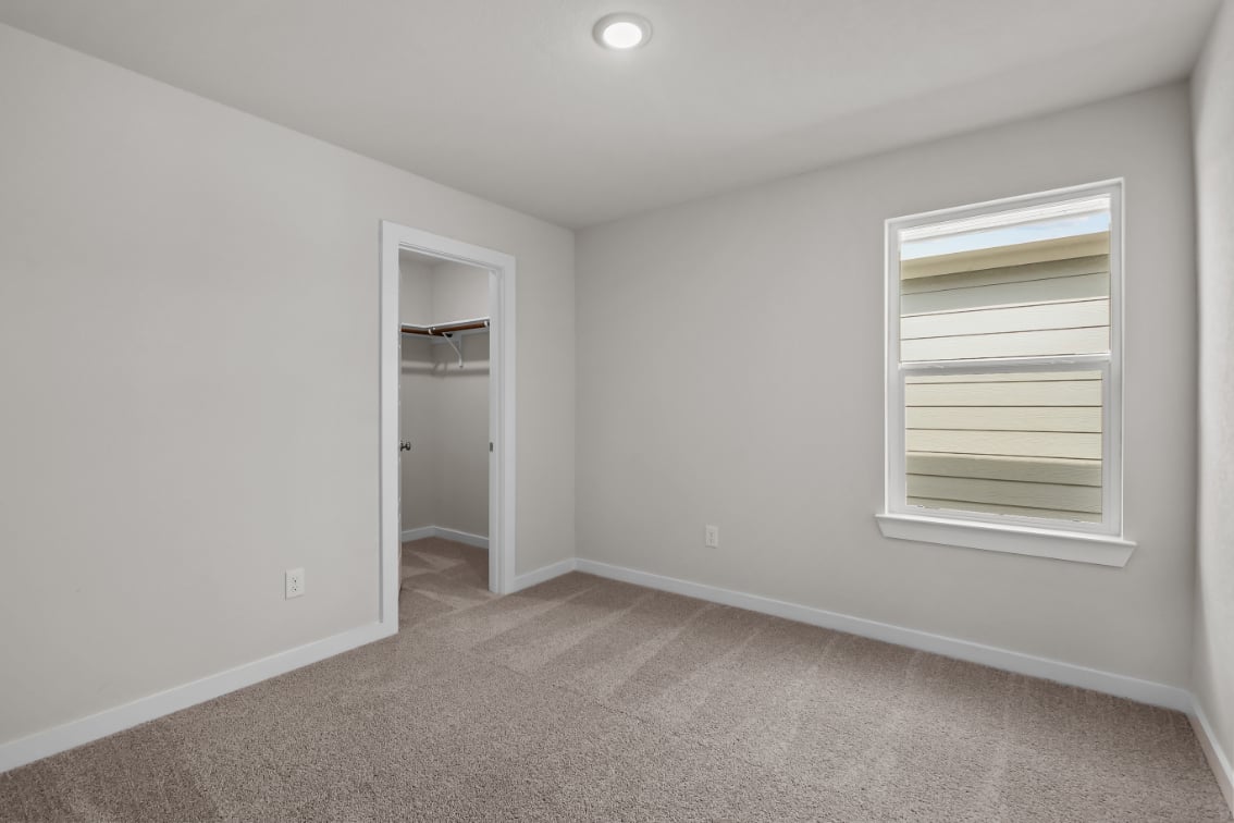 A room with a window and a door.