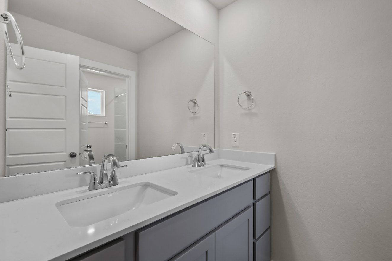 A bathroom with a large mirror.