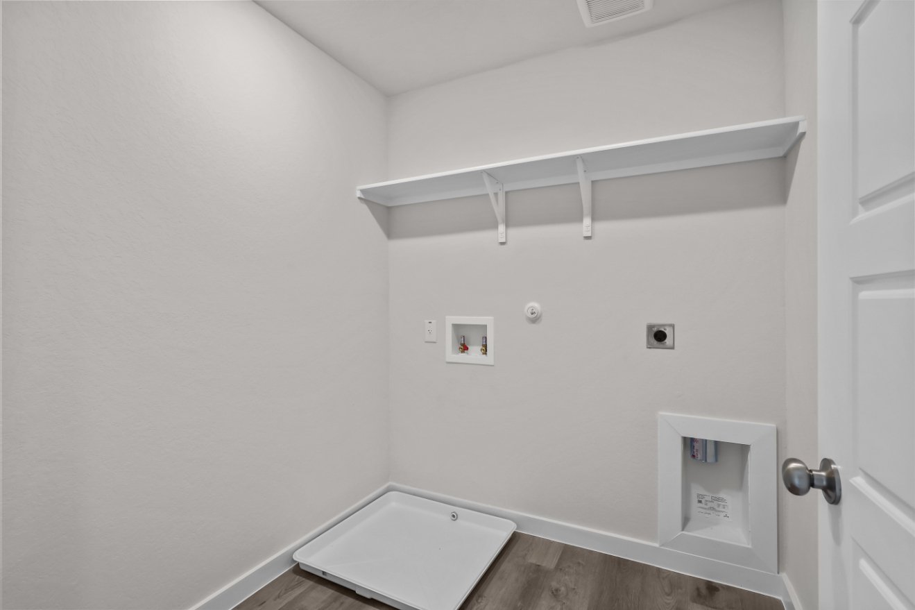 A white room with a sink and a white wall.