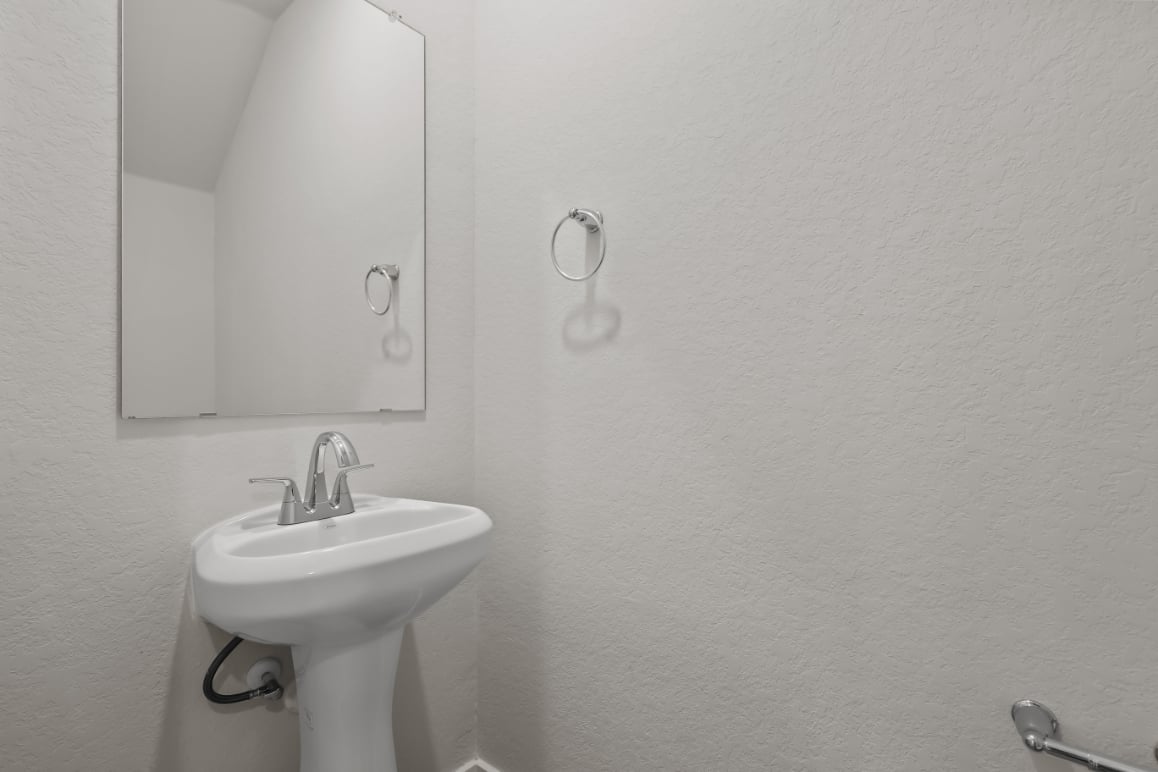 A bathroom with a mirror and sink.