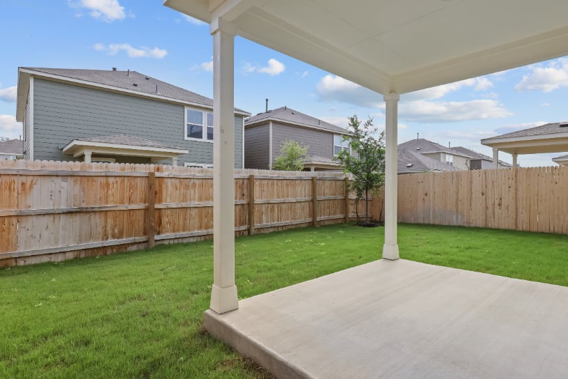 A backyard with a fence and a wood fence.