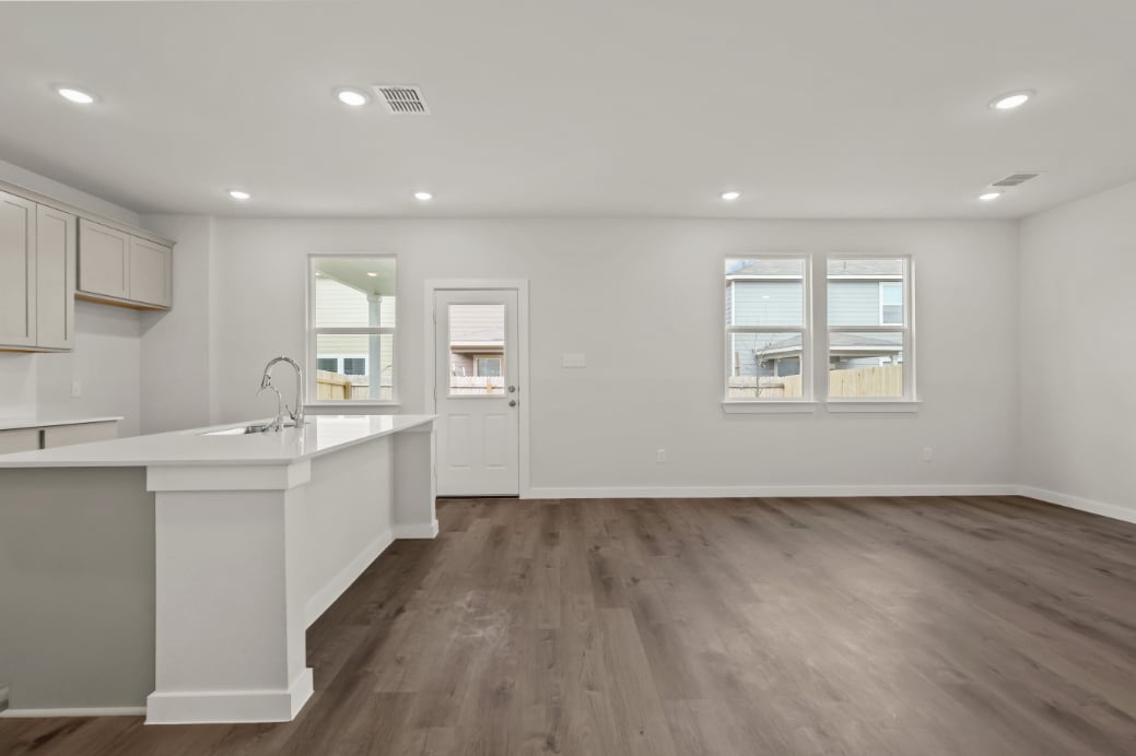 A kitchen with white cabinets.