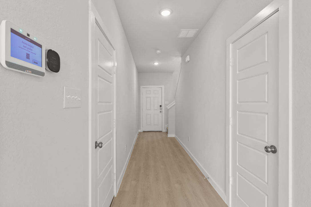 A hallway with white doors.