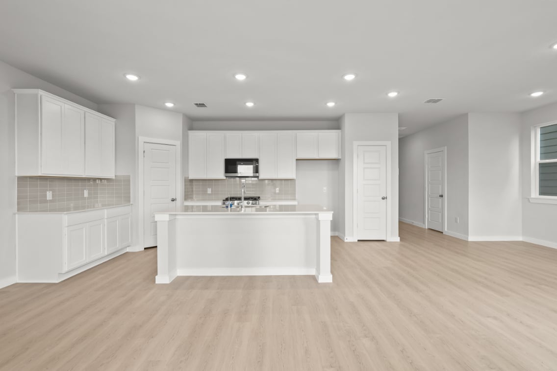 A large kitchen with white cabinets.