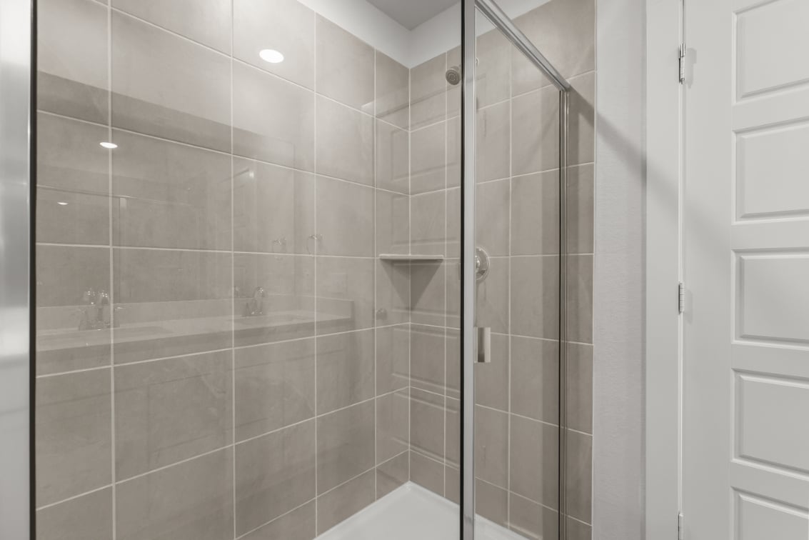A shower with glass doors.
