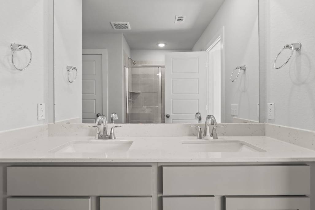 A bathroom with a large mirror.