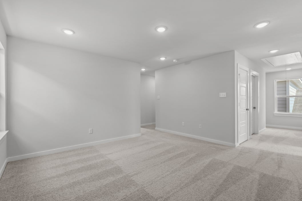 A room with white walls and a wood floor.