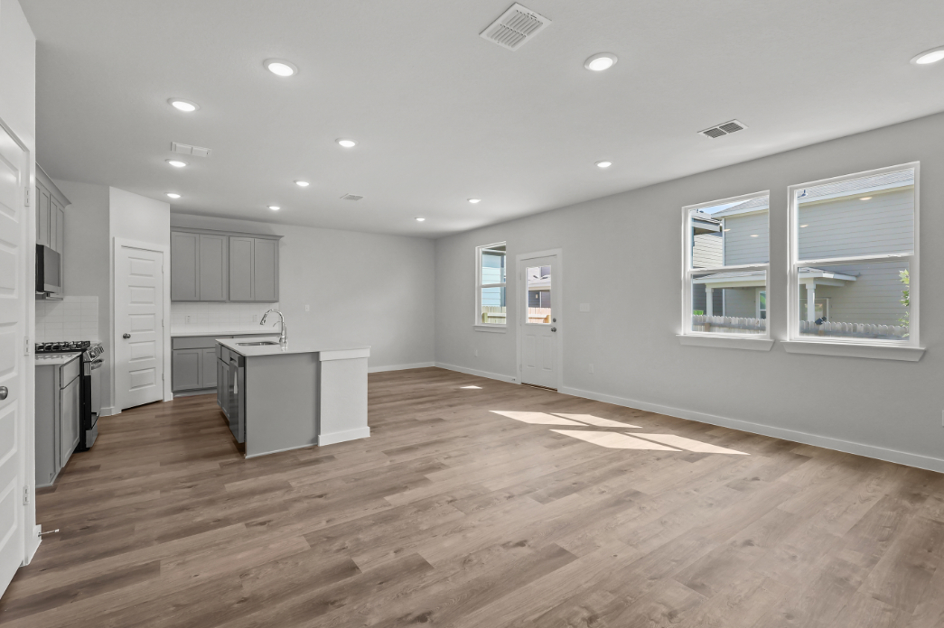 A kitchen with white cabinets.