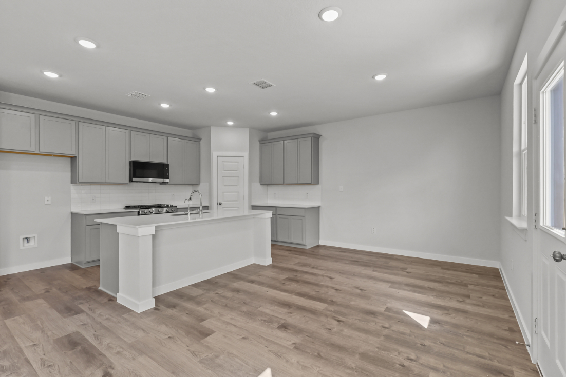 A kitchen with white cabinets.