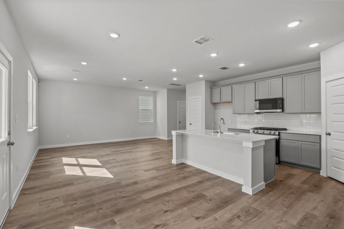 A large kitchen with white cabinets.