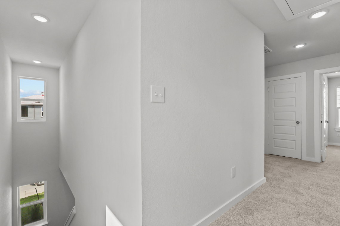 A white wall with a window.