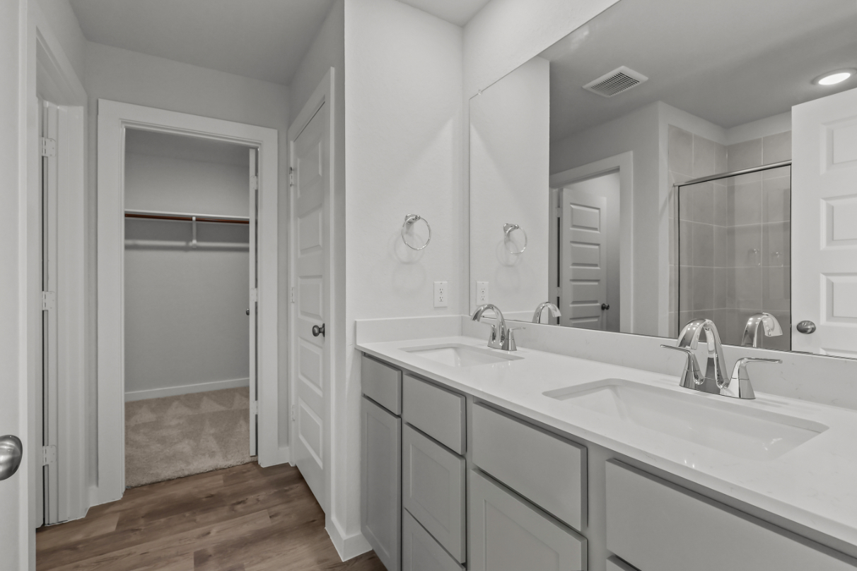 A bathroom with a large mirror.