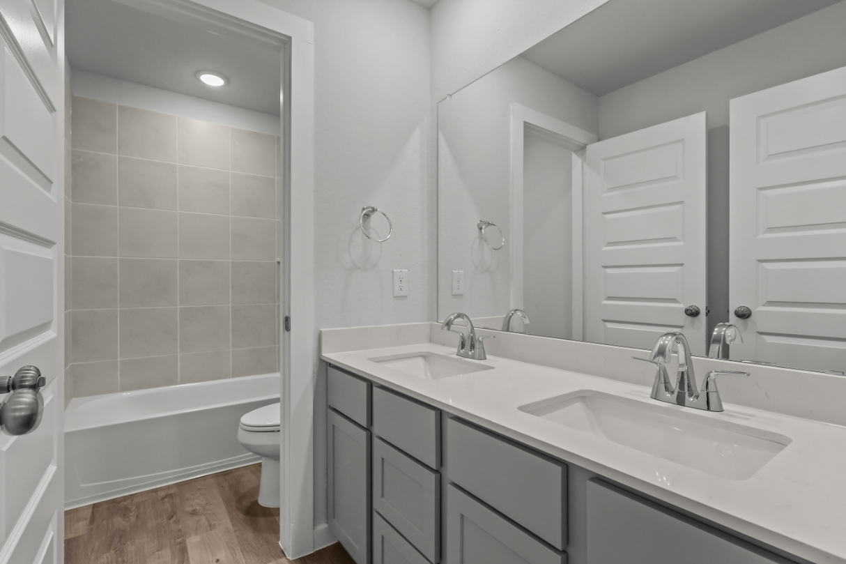 A bathroom with a tub sink and toilet.