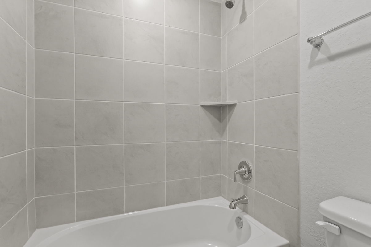 A bathtub in a bathroom.