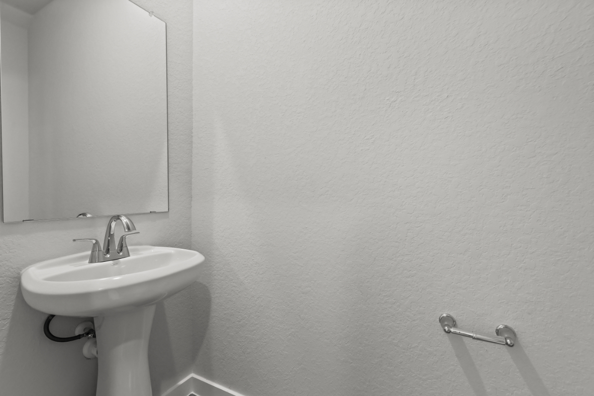 A bathroom with a sink and mirror.