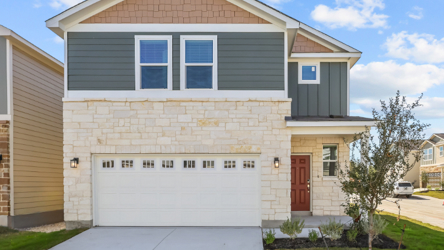 A white house with a garage.