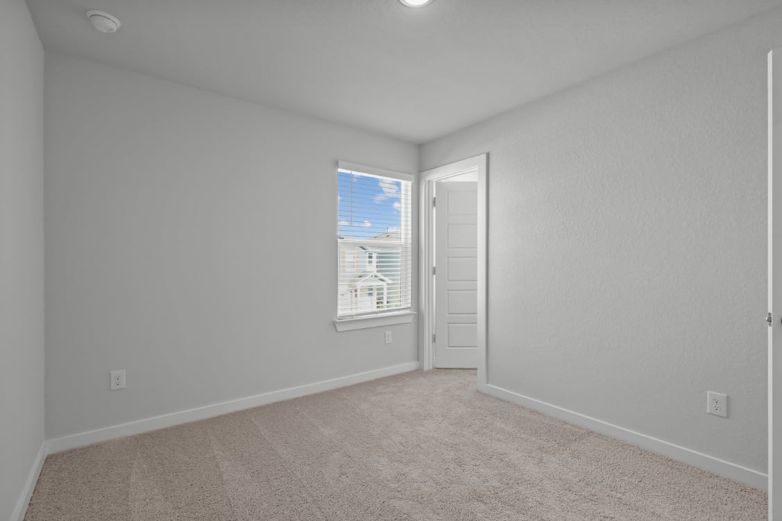 A room with a window and a door.