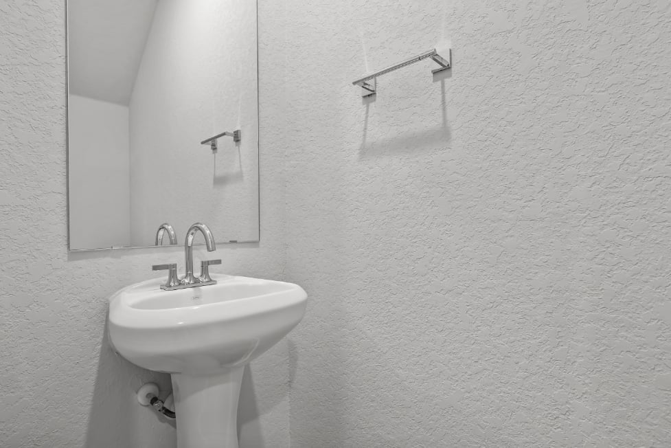 A bathroom with a sink and mirror.